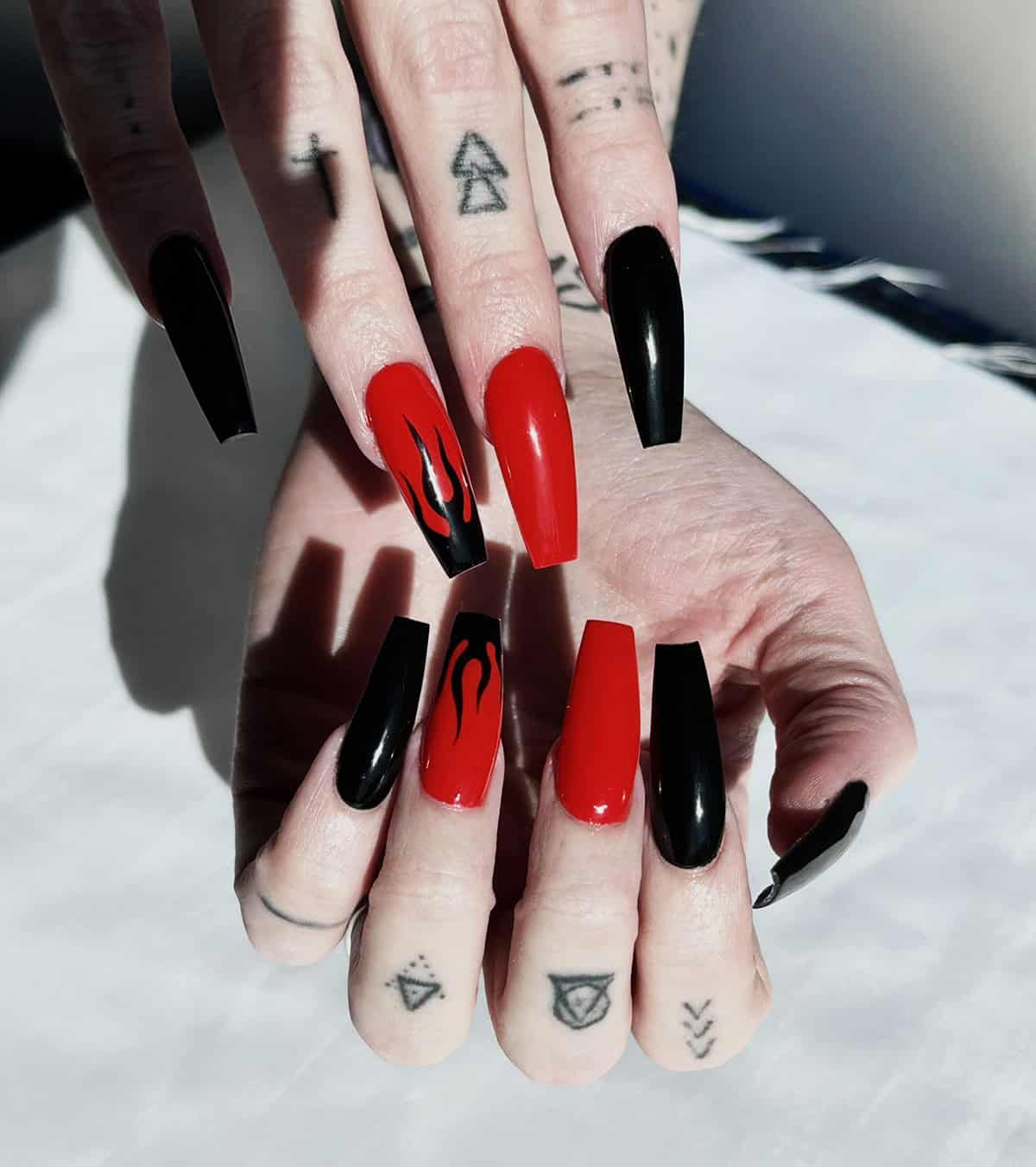 long coffin nails alternating red and black with matching flame accent nails fire nails