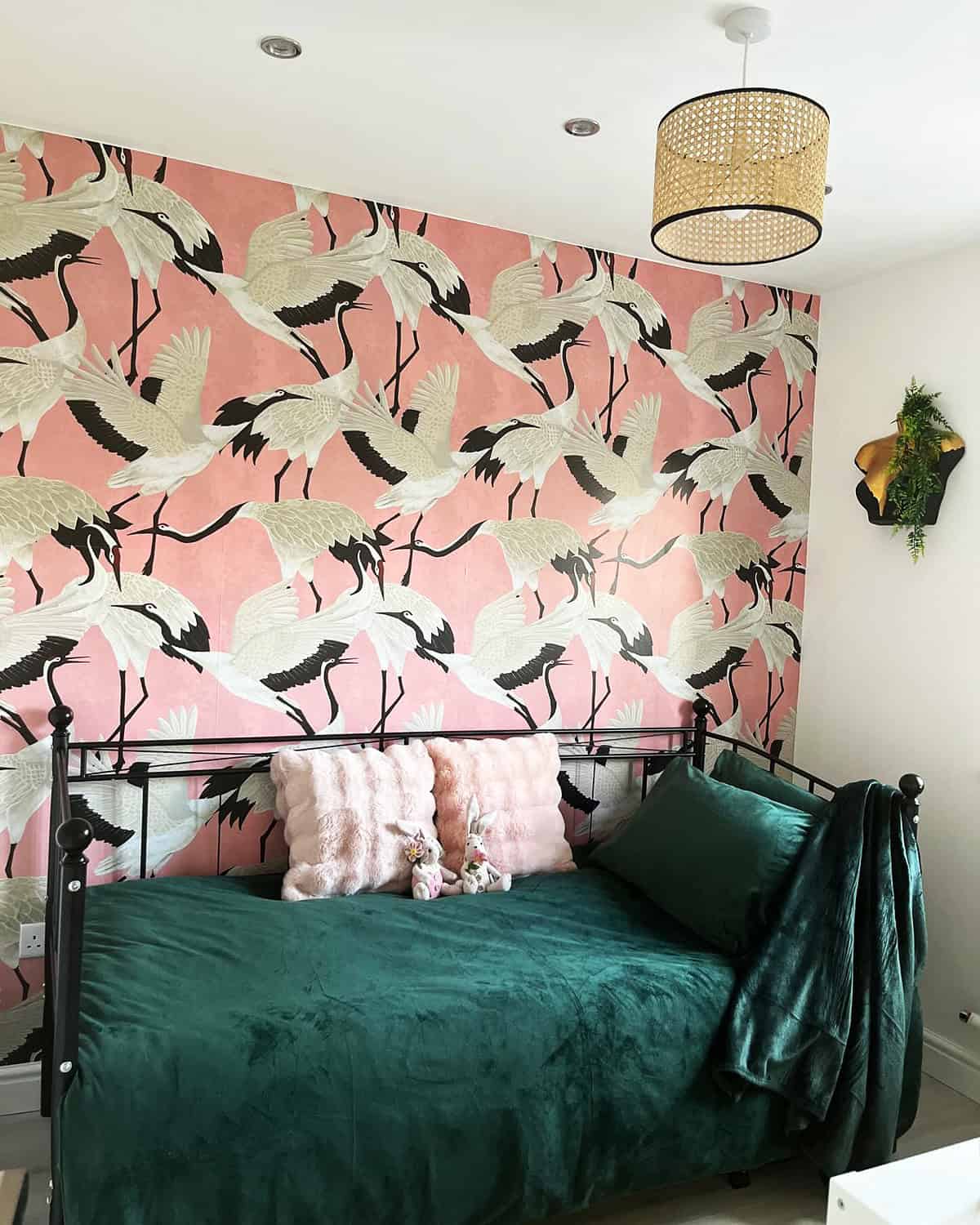 pink crane wallpaper with dark green velvet bedding in a cozy bedroom pink wallpaper ideas home decor