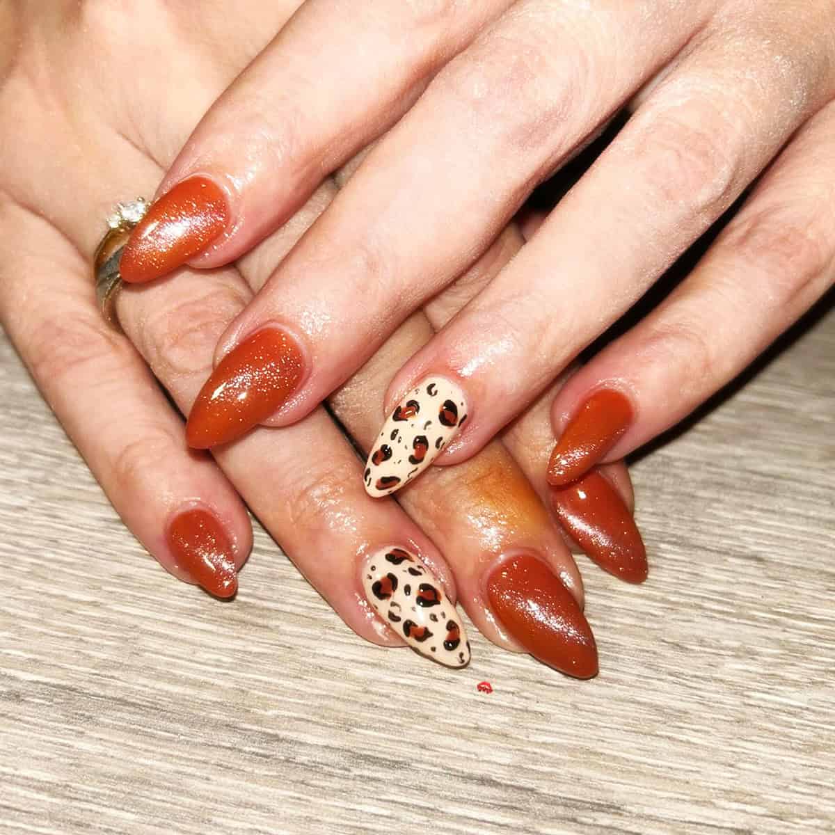 rust shimmer leopard accent nails fall leopard print nails