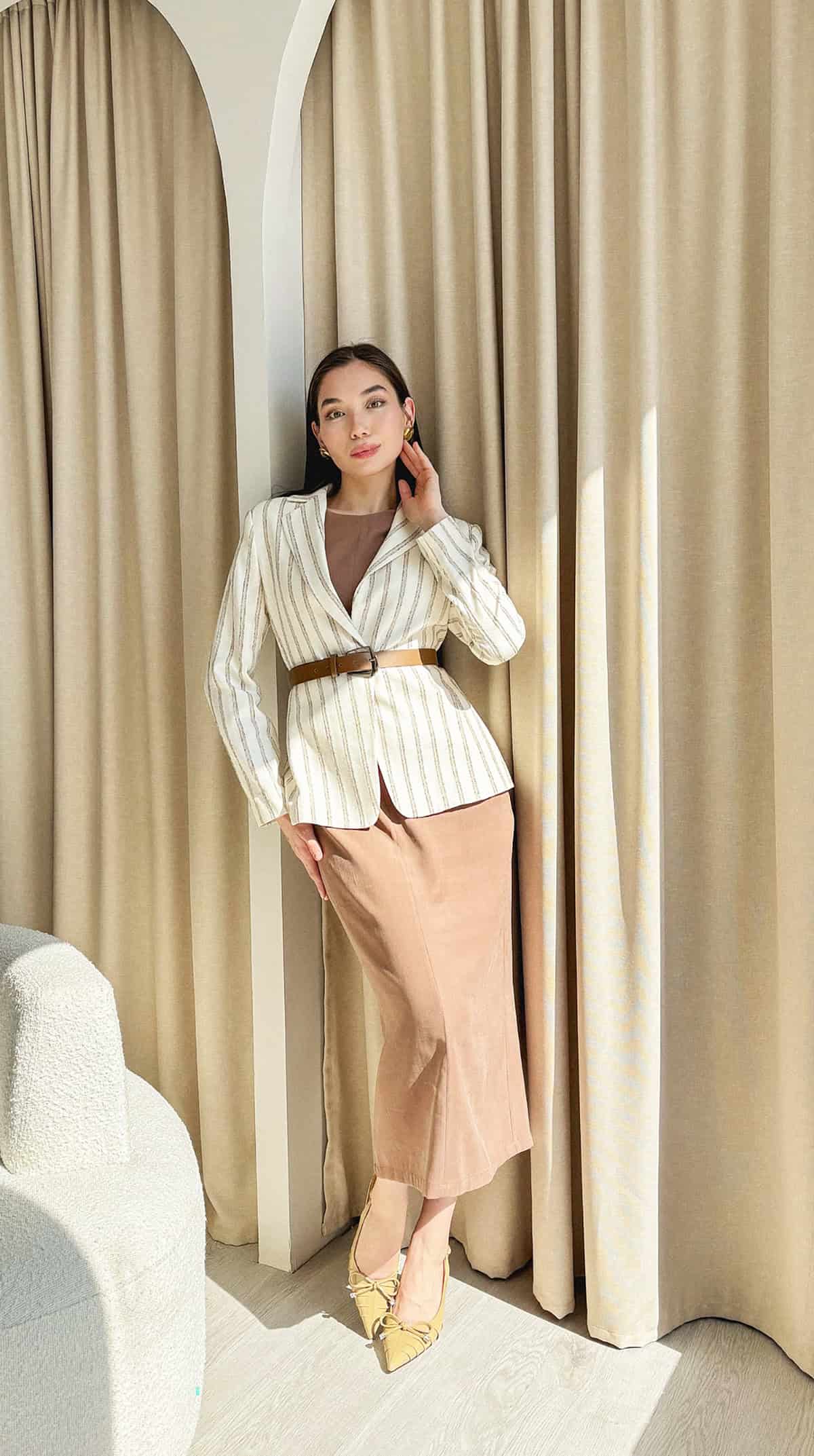 white striped blazer belted over a nude midi skirt with a matching top and yellow bow heels office attire for summer