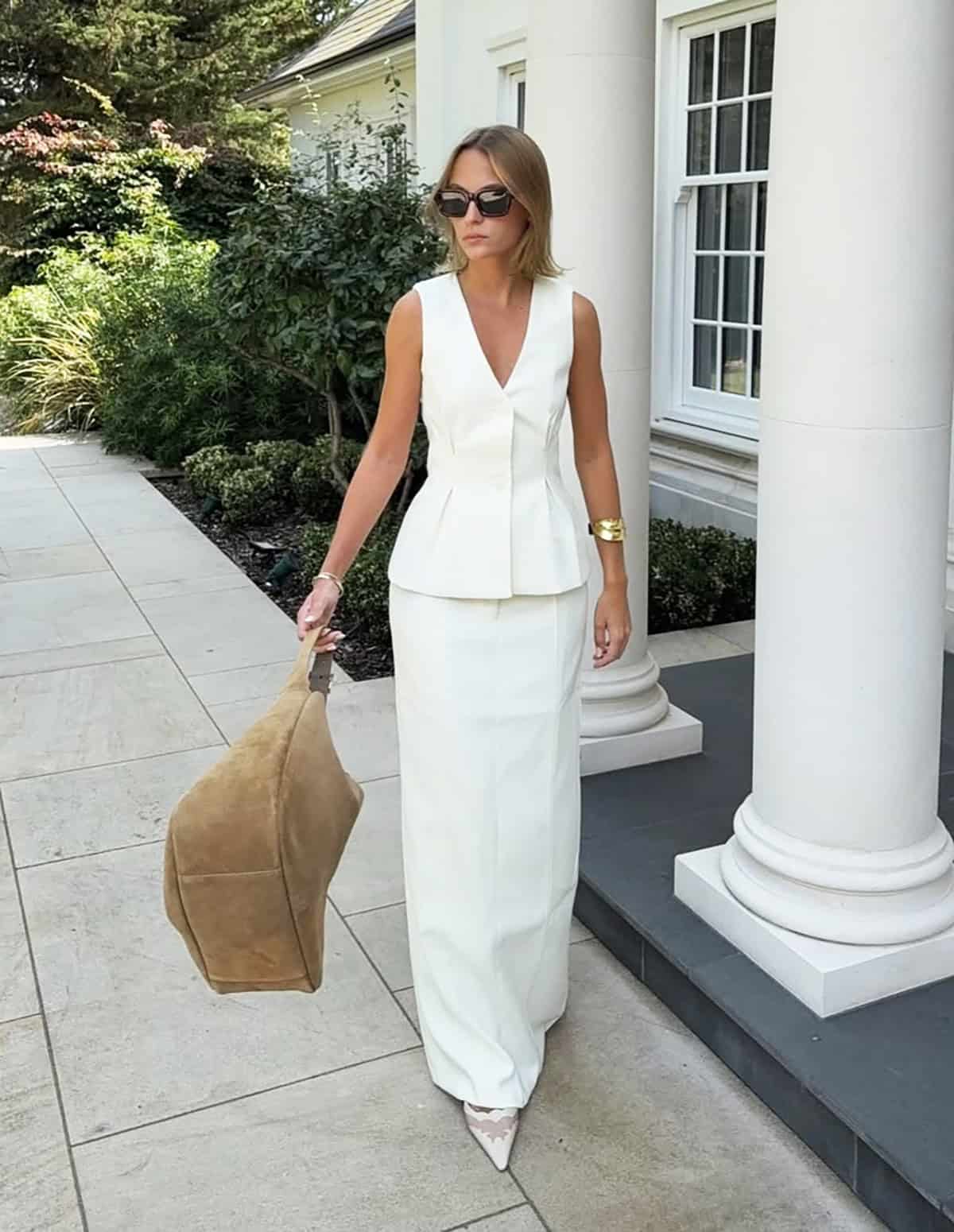 white sleeveless vest with matching long column skirt and pointed flats for a polished summer office look
