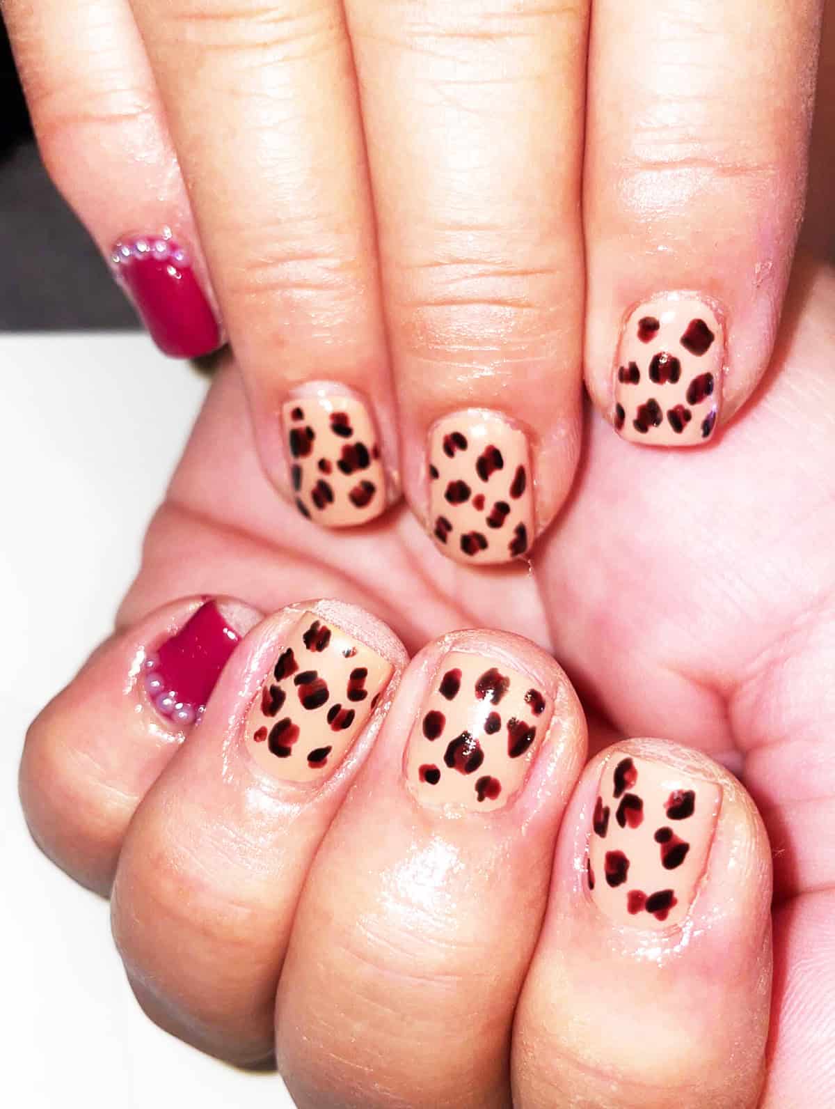 nude base dark spot short leopard print nails