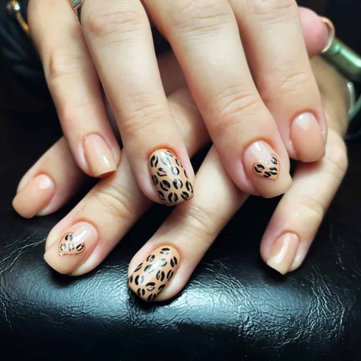 nude short leopard print accent nails with glossy finish
