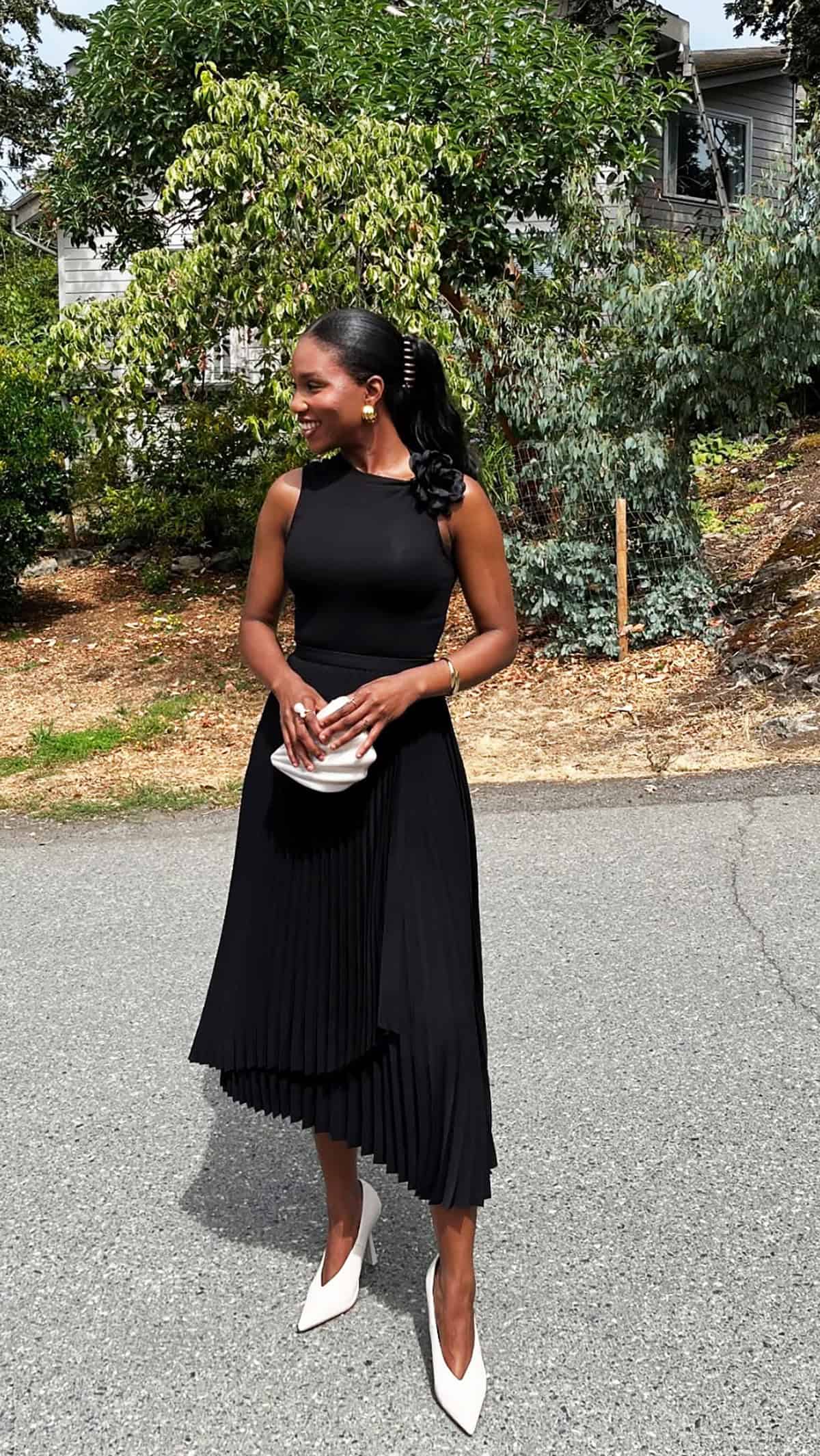 sleeveless black dress with asymmetric pleated midi skirt a office attire for summer