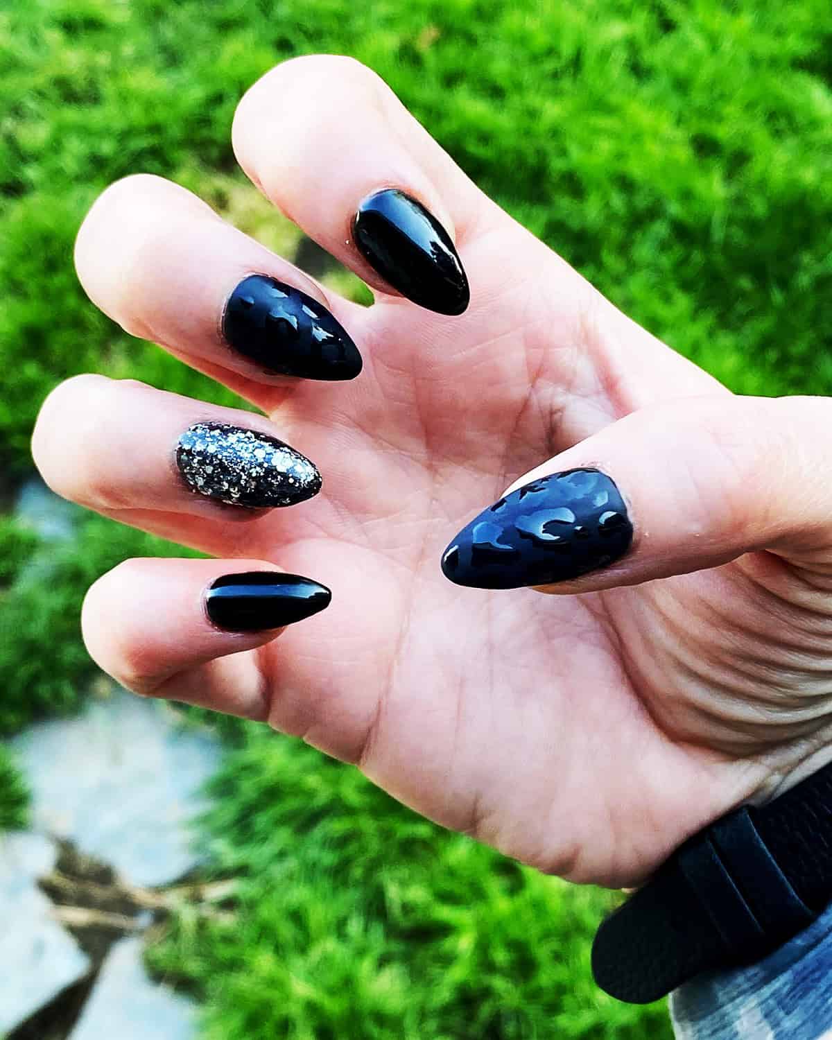 black stiletto glitter accent black leopard print nails