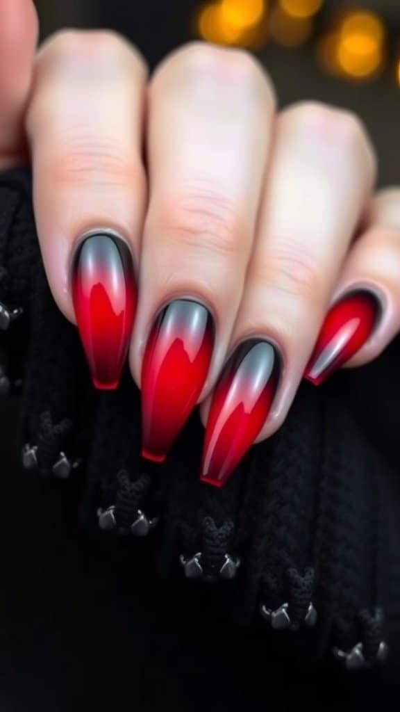 Acrylic nails with a fiery red to black gradient design.
