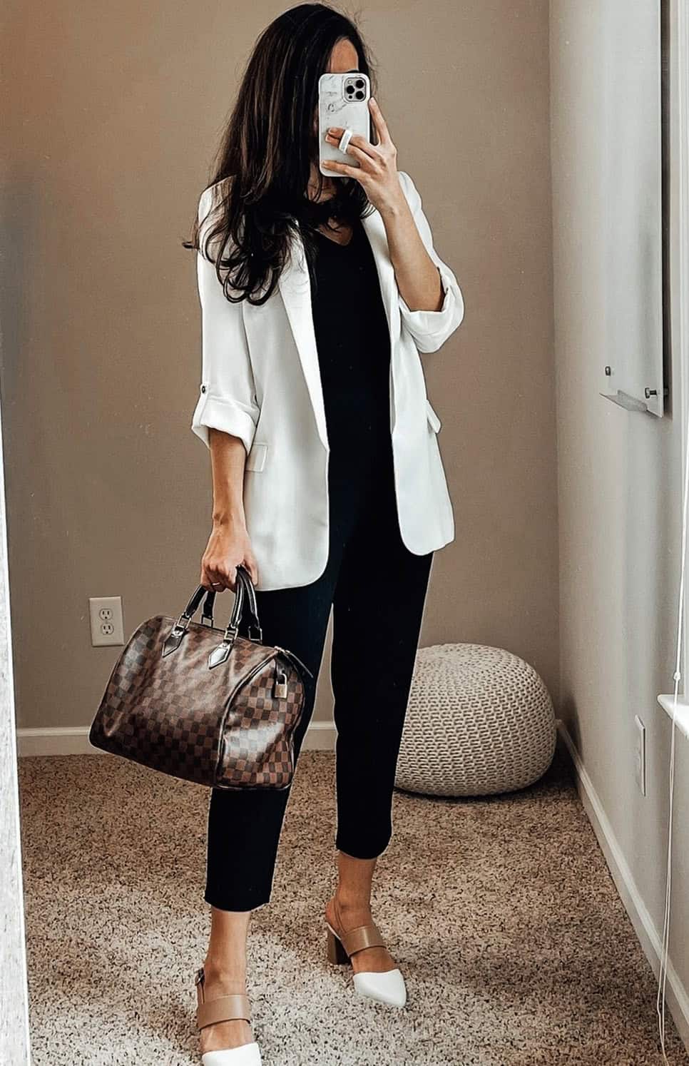white blazer over black outfit styled for a polished work look