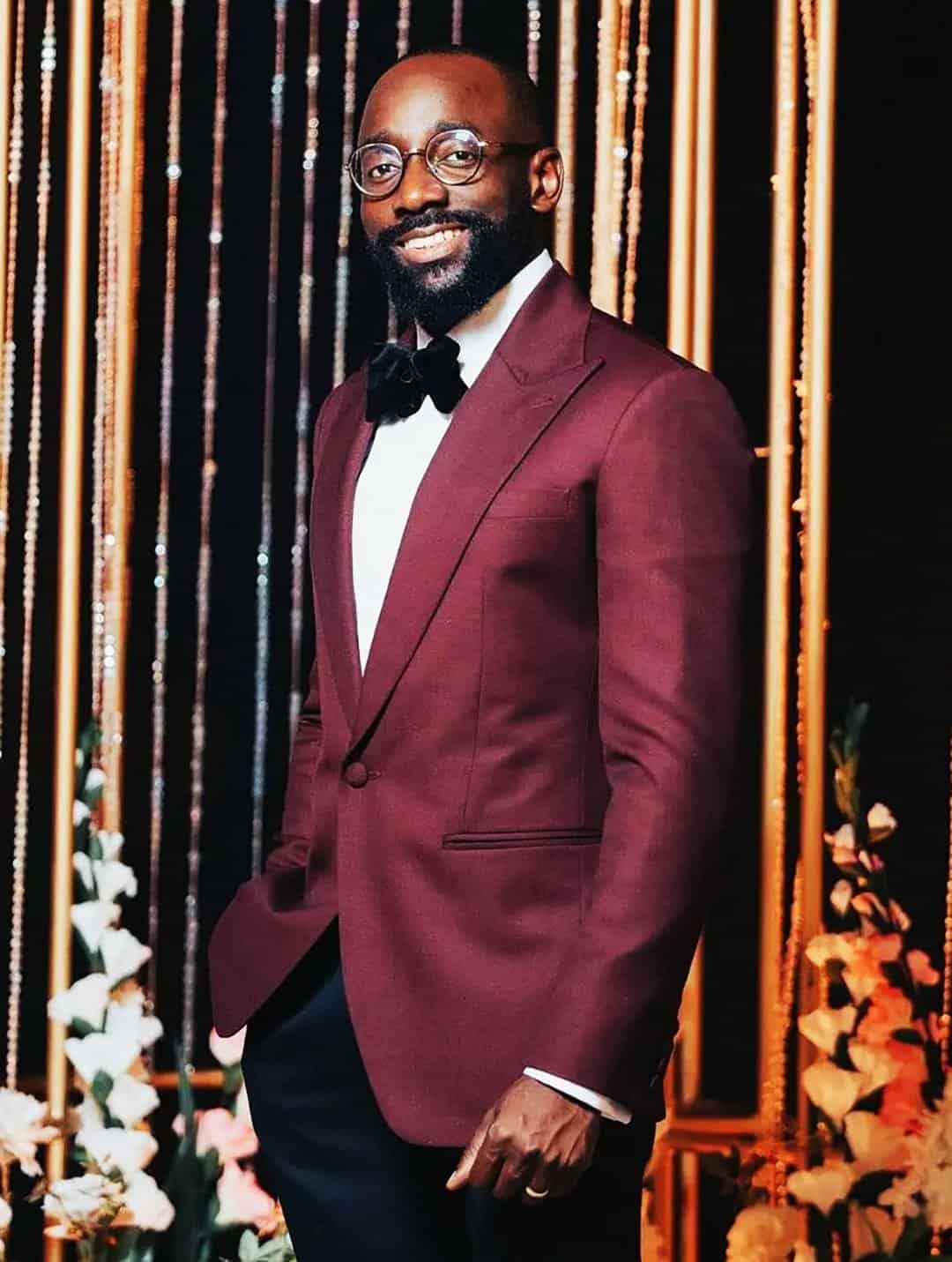 man in burgundy blazer with bow tie