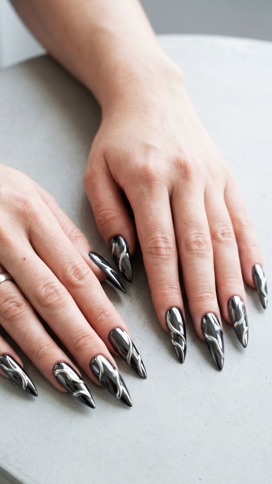 Black chrome nails with drip silver design