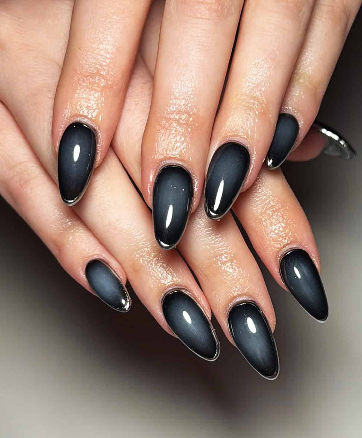 almond nails with matte to glossy black chrome fade effect black chrome nails