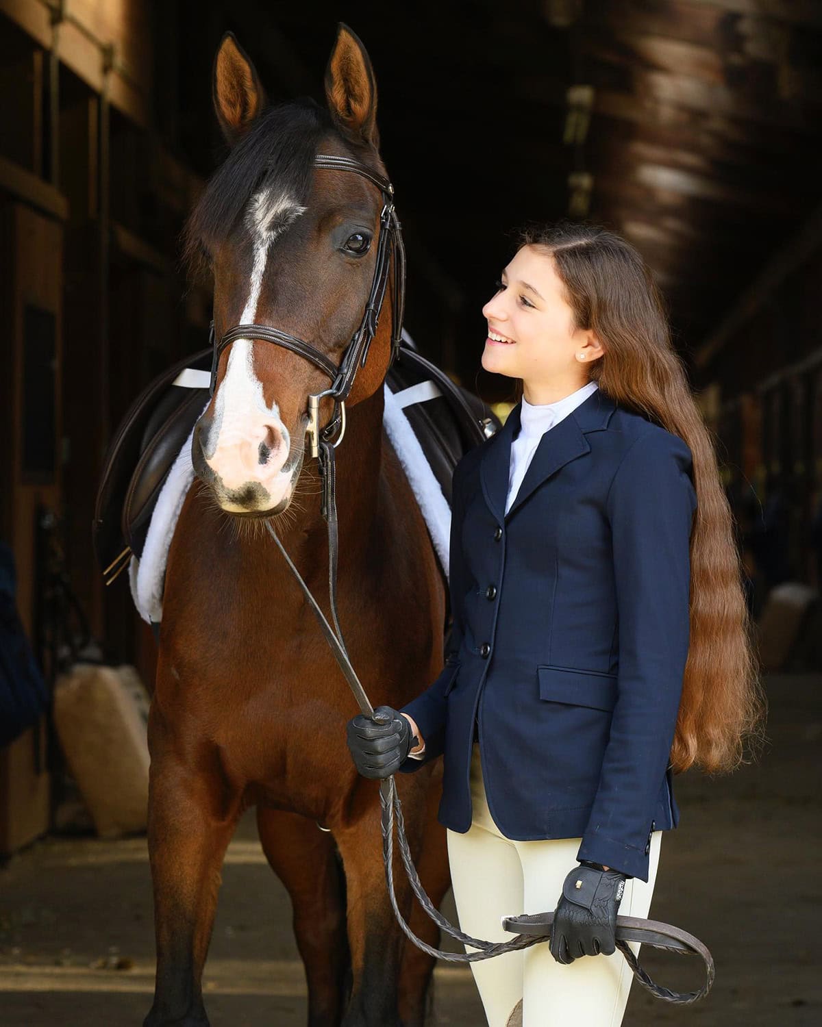 rider in navy show jacket with cream breeches, gloves, and structured fit for competition riding, Best equestrian outfits for English riding