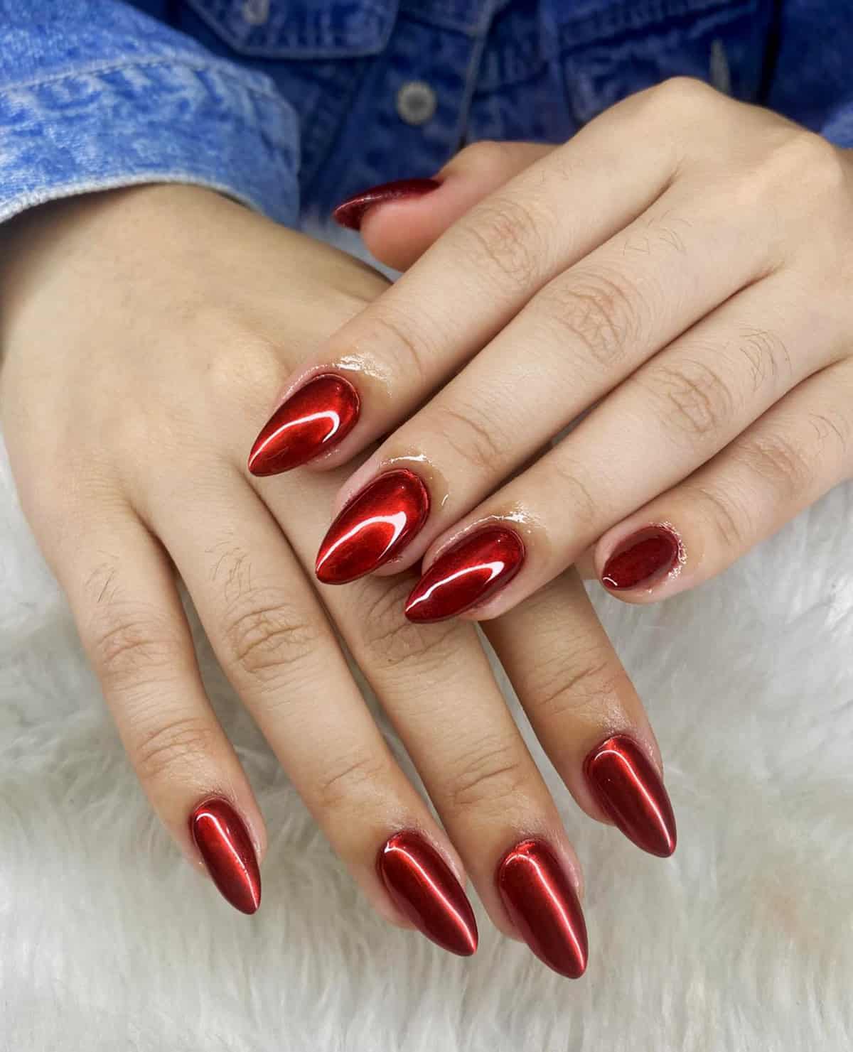 glossy bright red chrome almond nails with smooth reflective finish red chrome nails