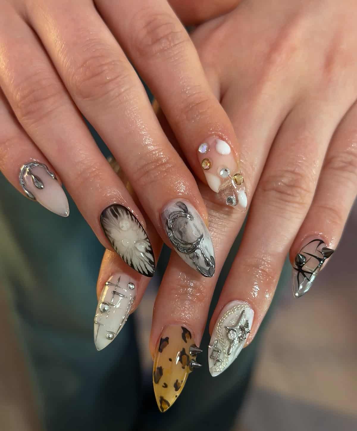 neutral tone nails with art and mixed embellishments baddie nails for summer