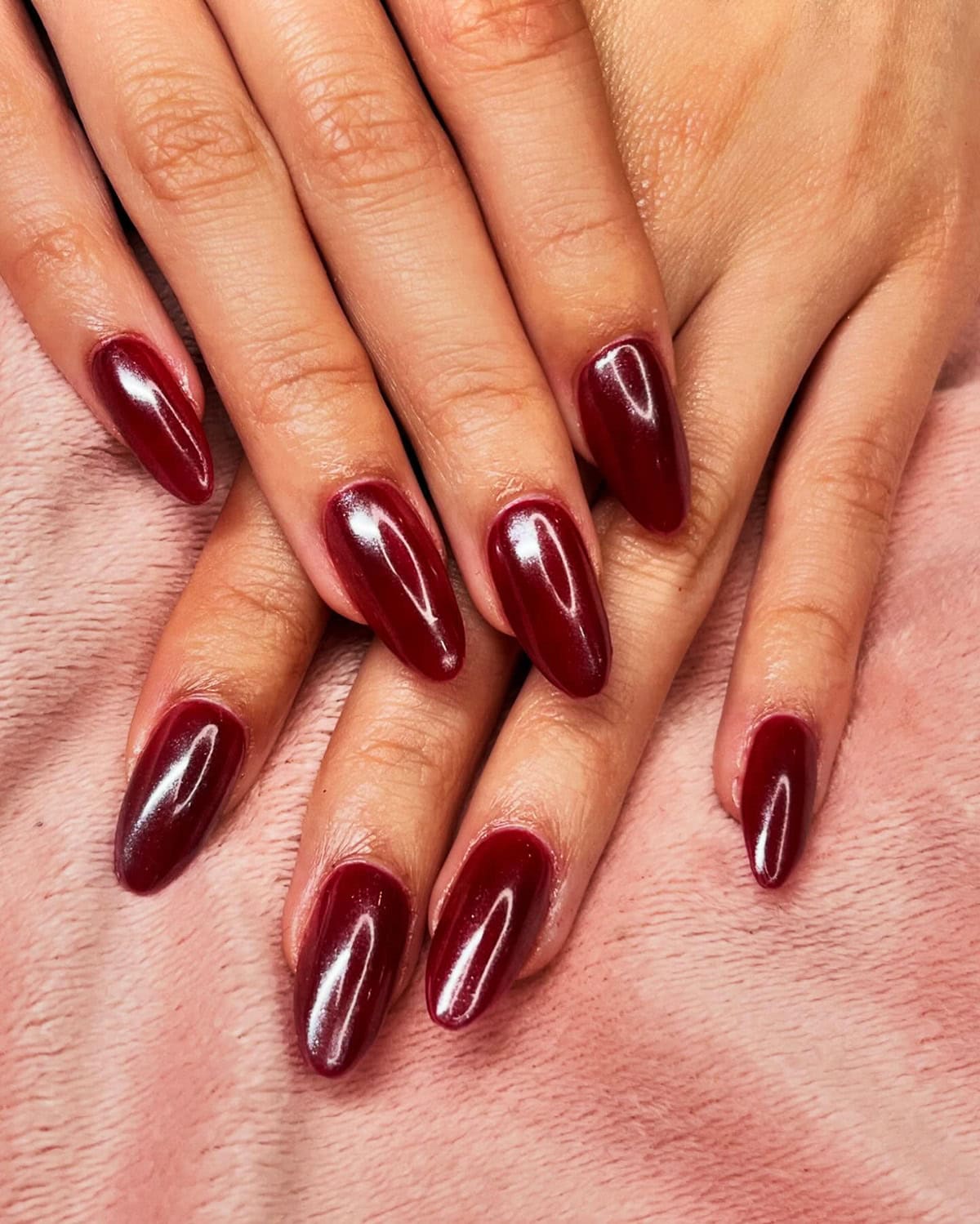deep cherry red chrome almond nails with glossy smooth finish red chrome nails