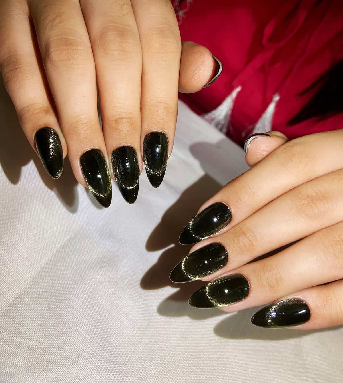 almond nails with cat-eye black chrome shimmer effect black chrome nails