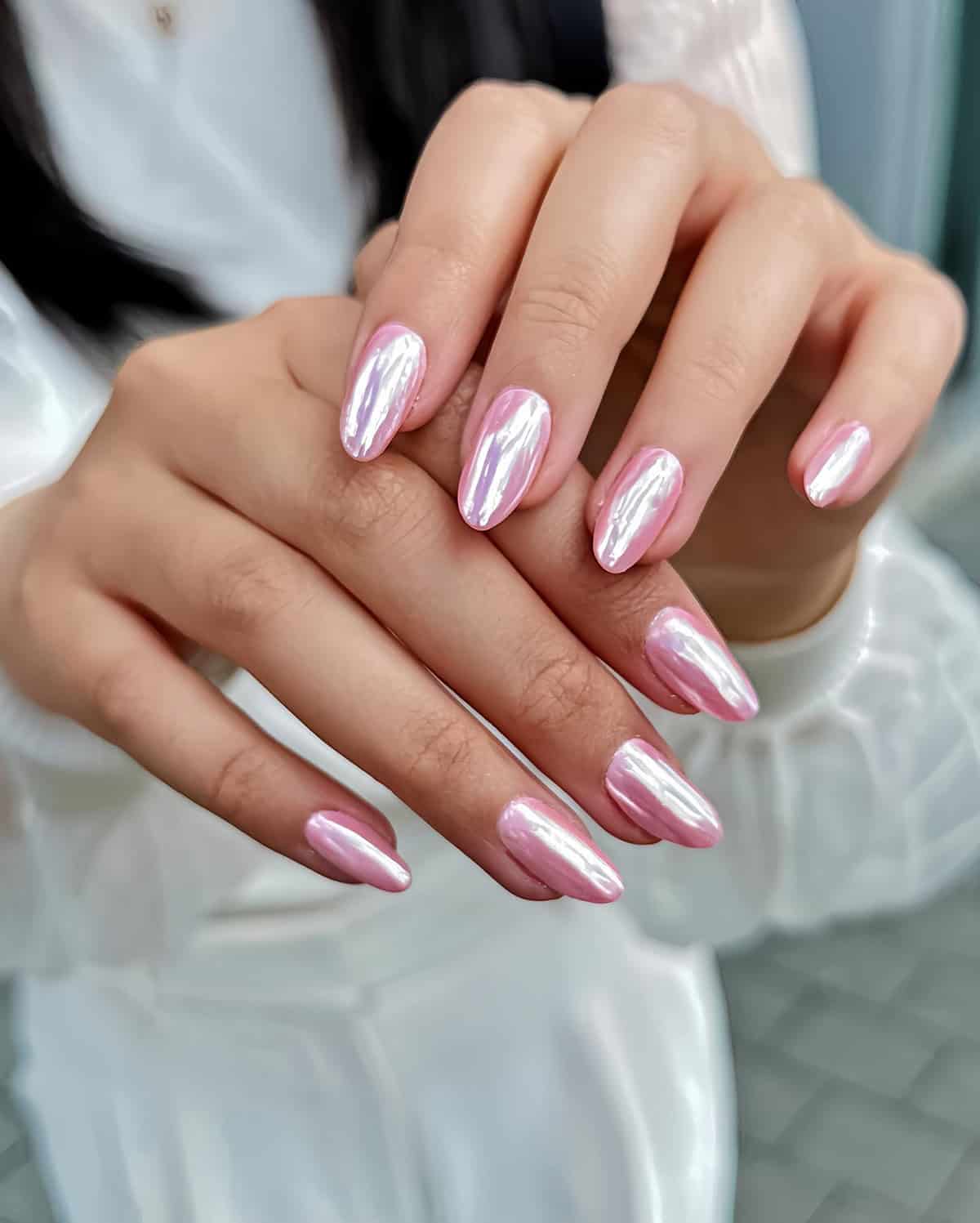 iridescent pink chrome almond nails with glossy reflective glow soft metallic finish pink chrome nails